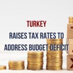 An image depicting a financial chart and Turkish flag with the title "Turkey's Tax Rate Hike: Addressing the Budget Deficit."
